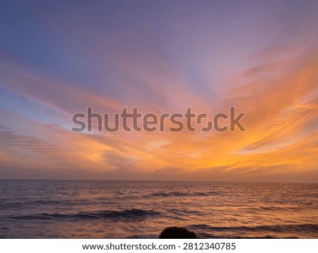 When the sky and the sea collapse into shades of dark red, the beach transitions from a place of tranquil beauty into a realm of Gothic intensity and mysterious power. This is a landscape where light is scarce, and the colors are deep, moody, and saturated with shadow.
The Dark Red Sky: A Somber Canopy
The sky is no longer a bright, fiery sunset; it has matured into a heavy, dramatic shroud of deep wine and bruised plum tones