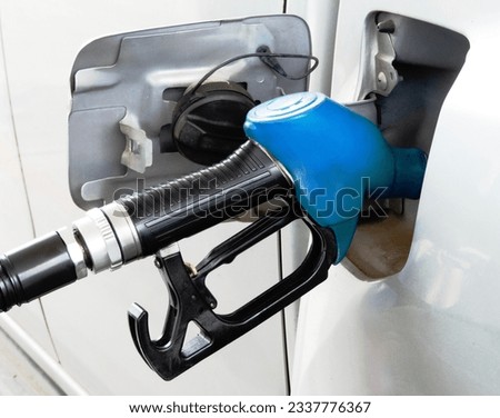 When it's time for car refueling on the petrol station, drivers pull up to the fuel pumps, turn off the engine, open the fuel tank cap. They select the type fuel they need, either gasoline or diesel, 