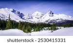 When traveling the Icefields Parkway from Banff to Jasper National Park, the snow-covered peaks of Mount Andromeda, Mt. Athbasca and Hilda Peak come into view when leaving Banff National Park. 