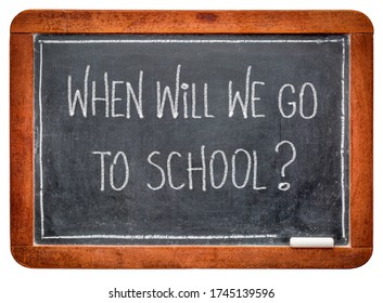 When Will We Go To School? White Chalk Hadwriting On A Vintage Slate Blackboard. Schools Reopening After Coronavirus Pandemic Concept.