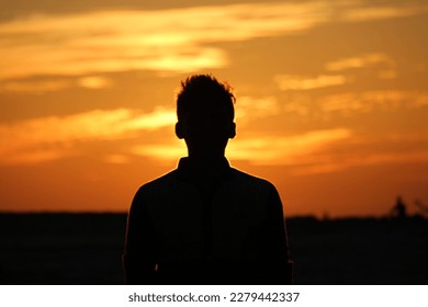 When your life is moving too fast and you find yourself in chaos, introduce yourself to each color of the sunset. - Shutterstock ID 2279442337