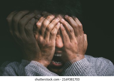 When your mind is your own worst enemy. Studio shot of a young man experiencing mental anguish and screaming against a black background. - Shutterstock ID 2169381703