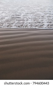 Where The Sand Meets The Ocean In Cannon Beach In Oregon