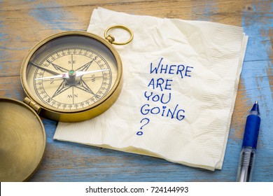 Where  are you going? -An essential question or searching for purpose  - a napkin doodle with a brass compass - Shutterstock ID 724144993