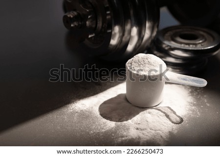 whey protein powder and dumbbell background ,Sports nutrition. Fitness or healthy lifestyle concept.