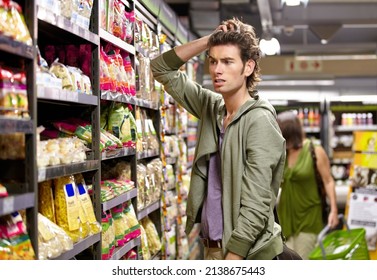 Which one am I supposed to get. A young man with his hands in his hair looking confused. - Powered by Shutterstock