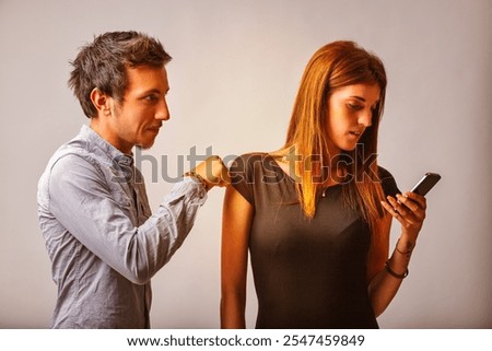 While he tries to get her attention, the woman looks intently at her phone, subtly turning it away from him. This moment highlights a disconnection, with her withholding focus