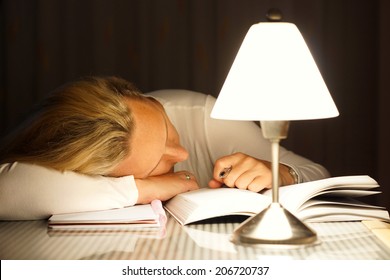 while learning the woman fell asleep on the table  late at night