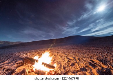 While Looking For Meteorites At Atacama Desert We Made A Stop For Sleeping In The Middle Of The Amazing Atacama Desert. A Camp Fire Under The Full Moon Light And Some Stars On The Cloud Sky. Chile