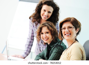 While  Meeting, Group Of Young Women Working Together On The Table