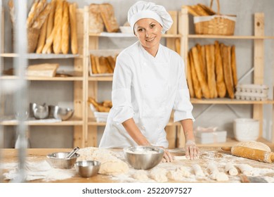 While working in bakery, female employee cooks croissants, rolls dough into tube, forms muffin from raw dough material, rolls up rolled out dough - Powered by Shutterstock