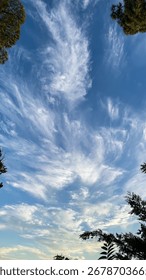 Whimsical cloud formations dance across cerulean skies like ethereal brushstrokes, celebrating Global Wind Day and Nebula Daydreams