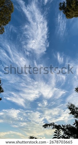 Whimsical cloud formations dance across cerulean skies like ethereal brushstrokes, celebrating Global Wind Day and Nebula Daydreams