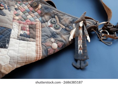 Whimsical handmade patchwork bag accessory with cute witch doll charm. This craft object features textile owl design, showing creative and magical folk art style