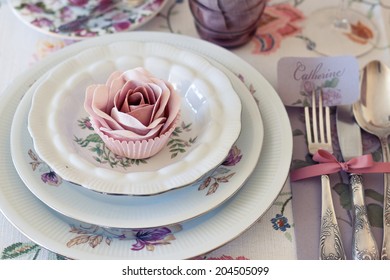 Whimsical Place Setting With Sugar Rose Cupcake On Vintage China. Sweet And Romantic Detail Of Tea Party Table. Perfect For A DIY, Vintage Or Farm Wedding. Shallow Depth Of Field.