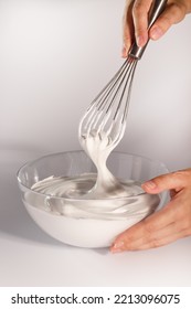 Whip The Cream With A Whisk In A Transparent Bowl. Whisk In Hand. Whipped Meringue.