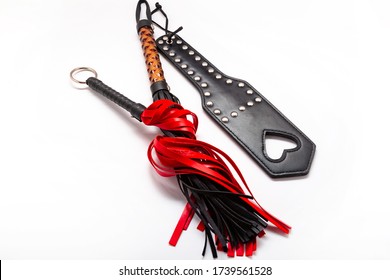 Whip on white background. Accessories for adult sexual games. Toys for BDSM, spanking devices. Spanking and punishment concept. Slave Spank Paddle, bdsm, adult whips. copy space. Set for bdsm