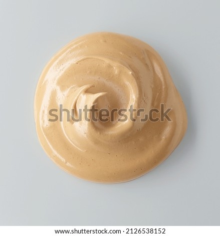 whipped caramel and coffee mousse cream isolated on grey background, top view