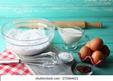 Whipped egg whites for cream on color wooden background
