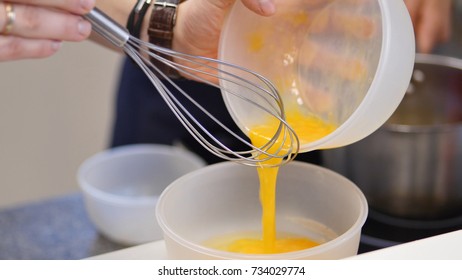 Whipped Egg Yolks With Sugar In A Glass Bowl. Beaten Egg Yolks In A Bowl With Whisk. Beaten Egg Yolk