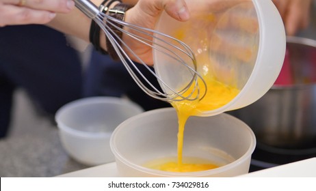 Whipped Egg Yolks With Sugar In A Glass Bowl. Beaten Egg Yolks In A Bowl With Whisk. Beaten Egg Yolk