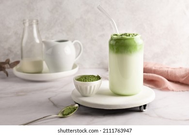 Whipped grean tea with milk, dalgona matcha latte in glass with matcha powder on white background. - Shutterstock ID 2111763947