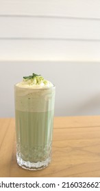 Whipped Green Tea With Milk, Matcha Latte, And Matcha Milkshake In A Glass With Matcha Powder On White Background.