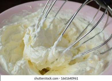 Whipping Icing Sugar And Whipped Cream In A Pink Bowl.