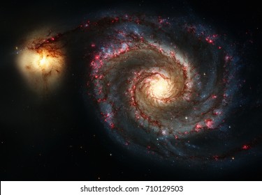 Whirlpool Galaxy and Companion. Winding arms of the spiral galaxy M51 or NGC 5194 appear like a grand spiral staircase sweeping through space. Elements of this image furnished by NASA. - Powered by Shutterstock