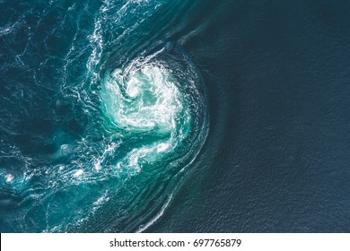 Whirlpools of the maelstrom of Saltstraumen, Nordland, Norway. Saltstraumen is a small strait with one of the strongest tidal currents in the world. By Letowa. - Shutterstock ID 697765879