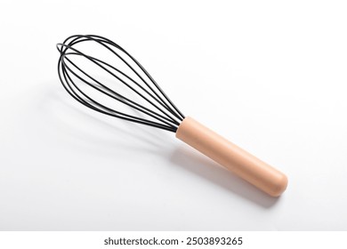 Whisk or egg beater isolated on white background. Silicone whisk with wooden handle, clipping path.
