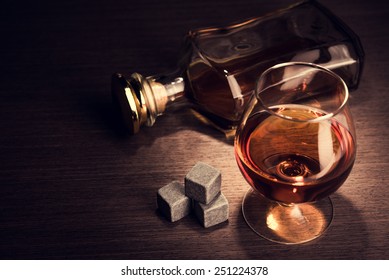Whiskey beverage in glass with stone. Alcohol background.