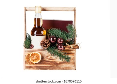 Whiskey bottle, Christmas tree decorations in a wooden box. New Year's gift set. Isolated on a white background. Space for text.  - Powered by Shutterstock