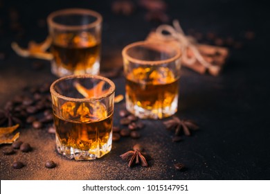 Whiskey, Brandy Or Liquor, Coffee Beans, Spices And Decorations On Dark Background. Seasonal Holidays Concept.