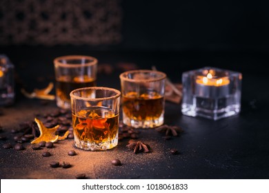 Whiskey, brandy or liquor, coffee beans, spices and decorations on dark background. Seasonal holidays concept. - Powered by Shutterstock