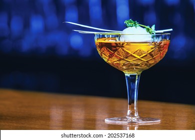 Whiskey Cocktail With Ice Ball On Bar In Pub Or Restaurant. 