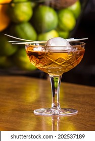 Whiskey Cocktail With Ice Ball On Bar In Pub Or Restaurant. 