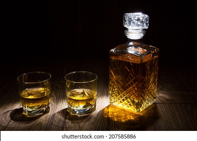 Whiskey Decanter With Two Glasses, Isolated On Black Background