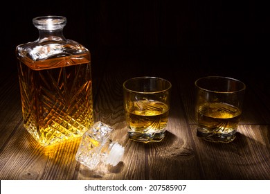 Whiskey Decanter With Two Glasses, Isolated On Black Background