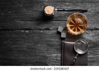 Whiskey in the drinking glass on the detective desk table background concept. Top view. - Shutterstock ID 2192383107
