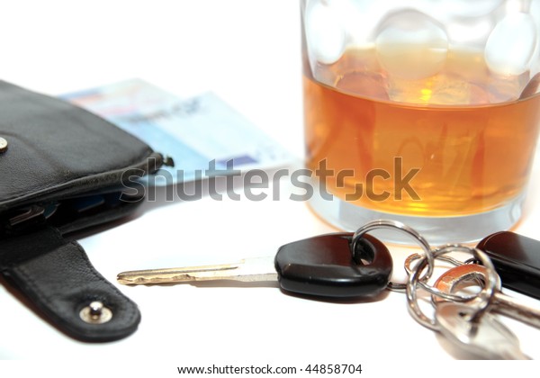 whiskey glass\
with car keys and cash on white background depicting gambling with\
drunk driving and addictions can\
kill