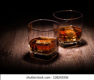 Whiskey In Glasses On Wooden Table