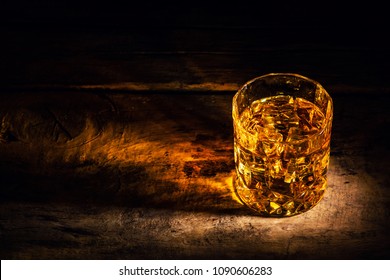 Whiskey With Ice Cubes On Wooden Background