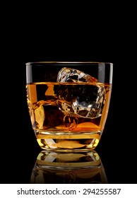 Whiskey with ice in glass isolated on black background with clipping path 