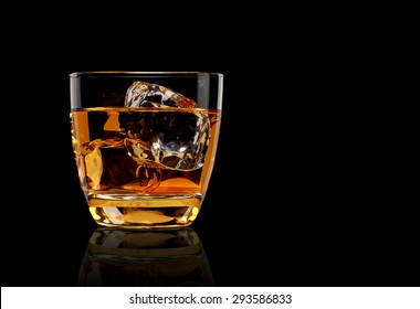 Whiskey with ice in rocks glass isolated on black background with clipping path 