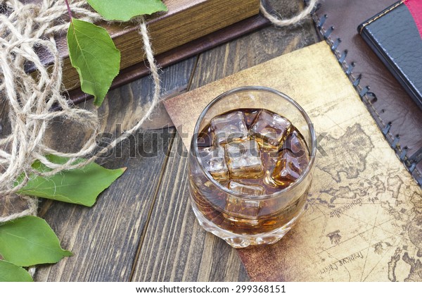 whiskey on a table\
with an old card and\
keys