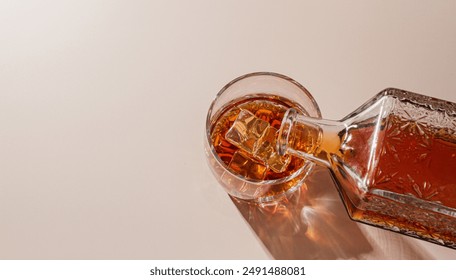 Whiskey is poured into a glass with ice
