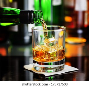 Whiskey Pouring A Glass In A Bar.