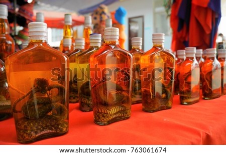 Whiskey prepared by locals on an island off the coast of Laos, at the Golden Triangle Special Economic Zone Chinatown. These brews contain either a previously live cobra, scorpion, or tiger genitalia.
