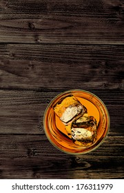 Whiskey In Rocks Glass With Ice Cubes From Top View On Wooden Background 